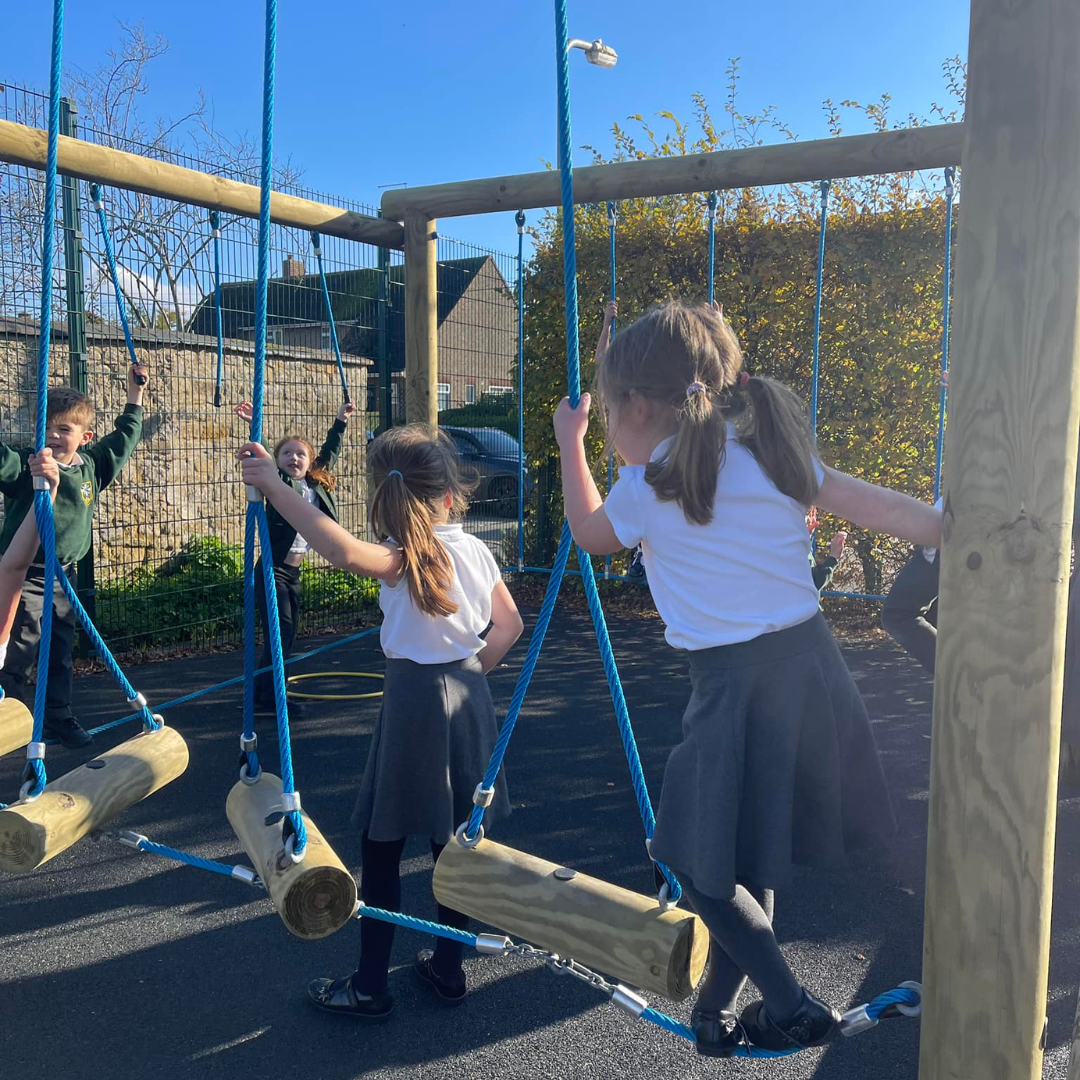 pupils playing on outdoor equipment