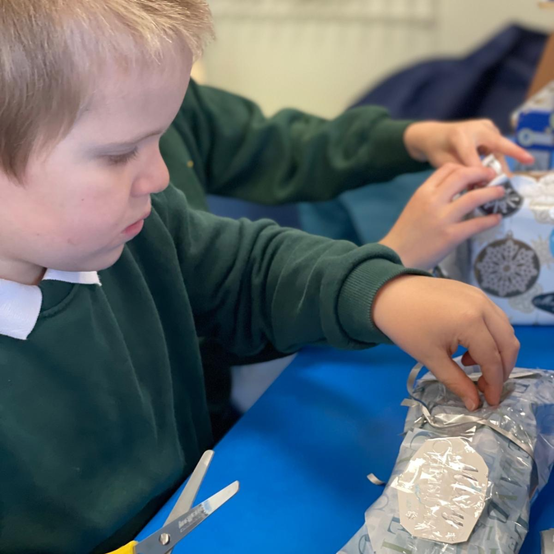 a pupil wrapping a present