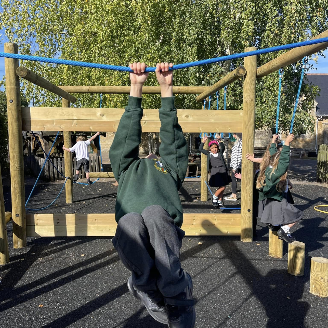 pupils playing on outdoor equipment